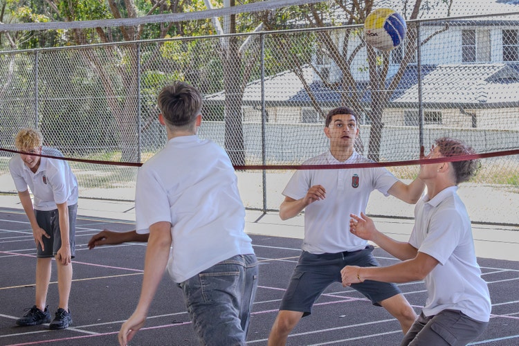 A Group Of Students Playing Volleyball