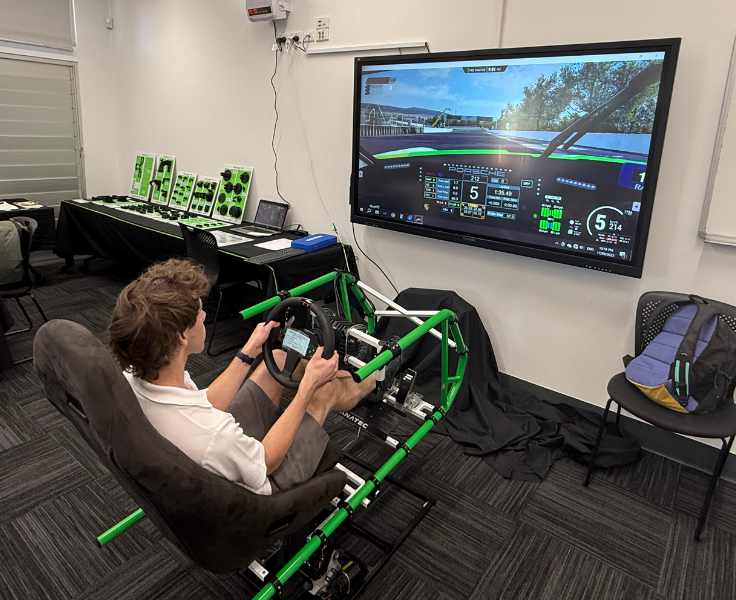 a student in a racing car simulator