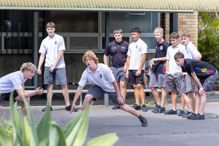 competitive game of handball with a group watching the game intensively