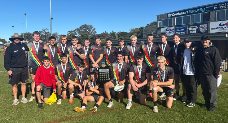 a group photo of a studentrugby team with their coaches and teaching staff