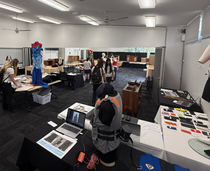 a photo of a room full of students textile and woodworking designs