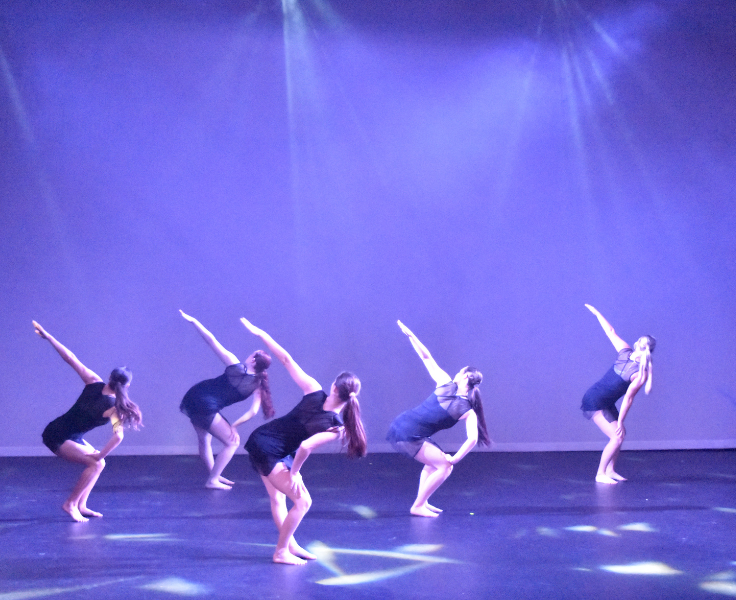 a group of dancers on stage