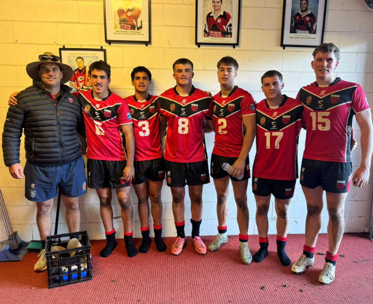 a group of students and a coach wearing football jerseys