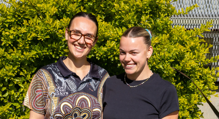 TEC Student Support Officers Katie and Summa standing outside