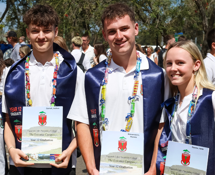 Three year 12 graduates smiling with their certificates
